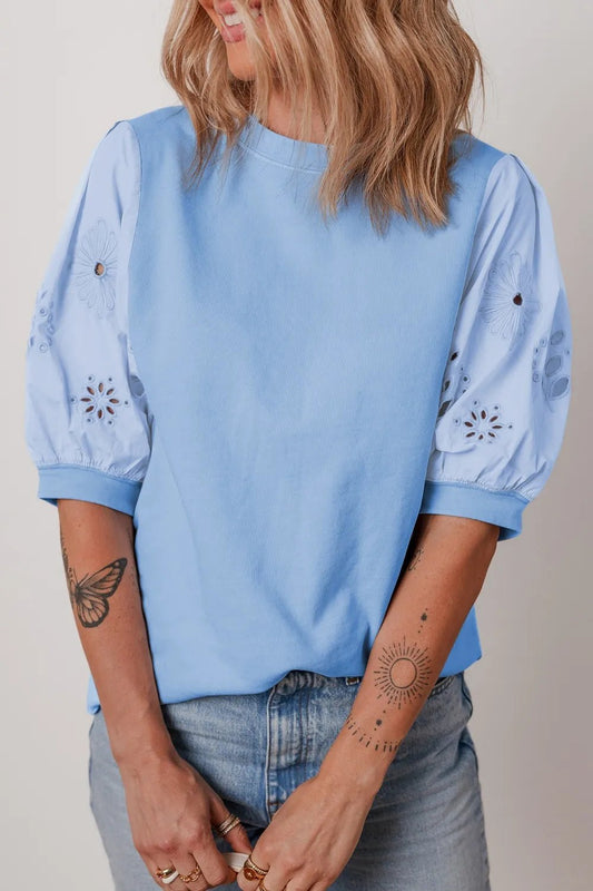 Front view of Eyelet Flower Embroidered Puff Short Sleeve Patchwork Crew Neck Blouse in Light Blue showing neckline and sleev