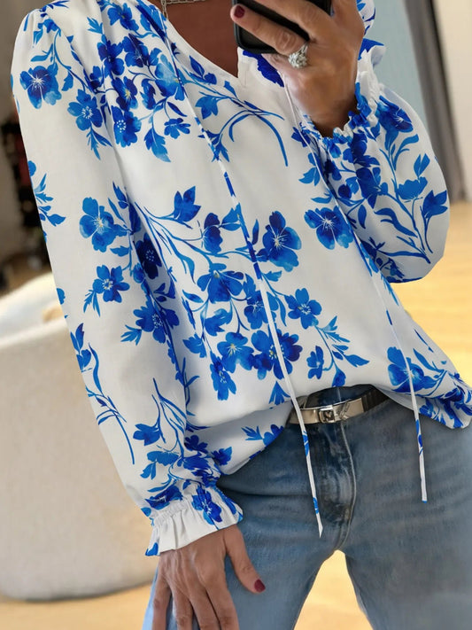Front view of Floral Long Sleeve Tie Neck Blouse in Sky Blue showing neckline and sleeve details (100% polyester Care)