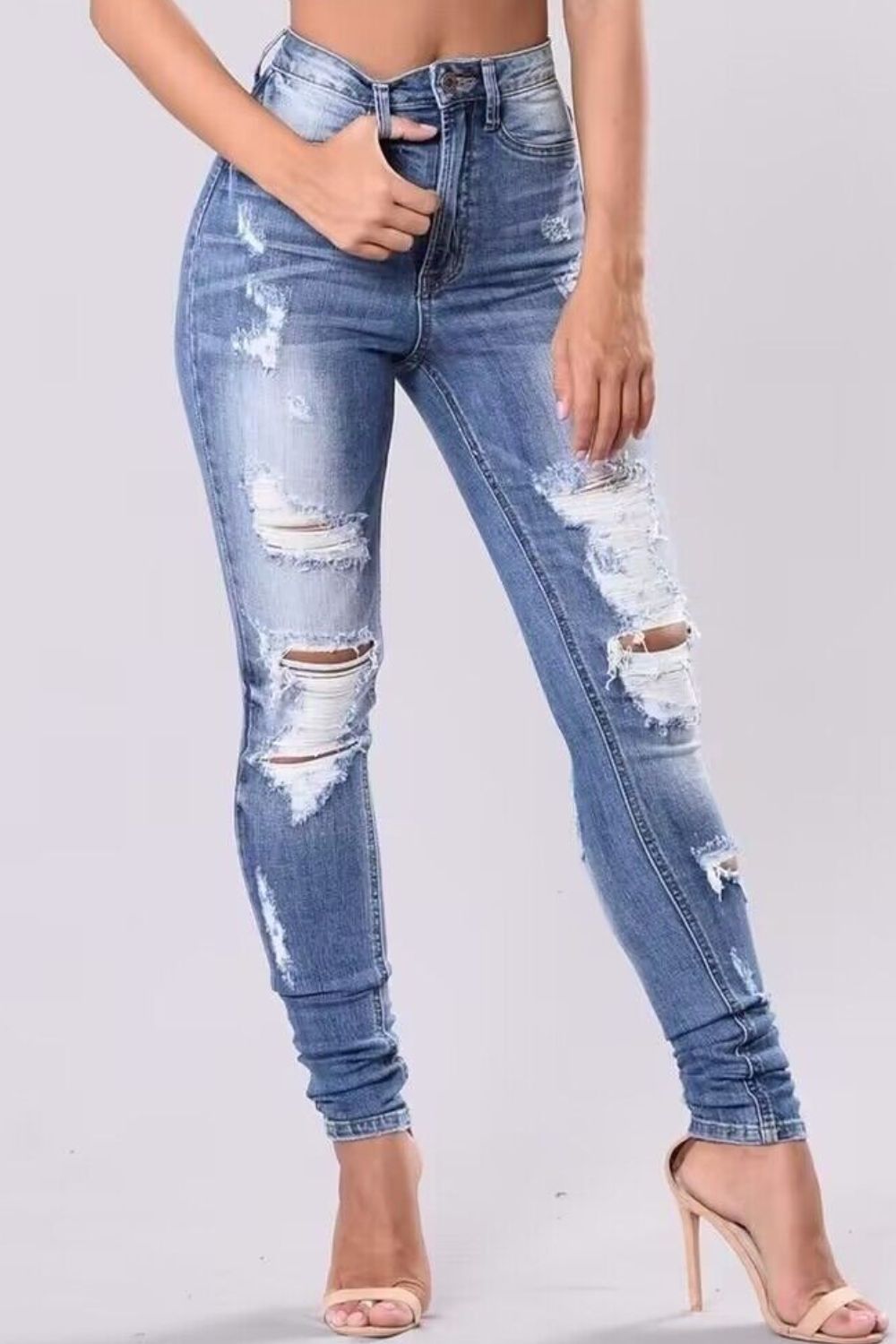 Front view of Full Size Distressed Skinny Jeans Plus Size in Light showing neckline and sleeve details