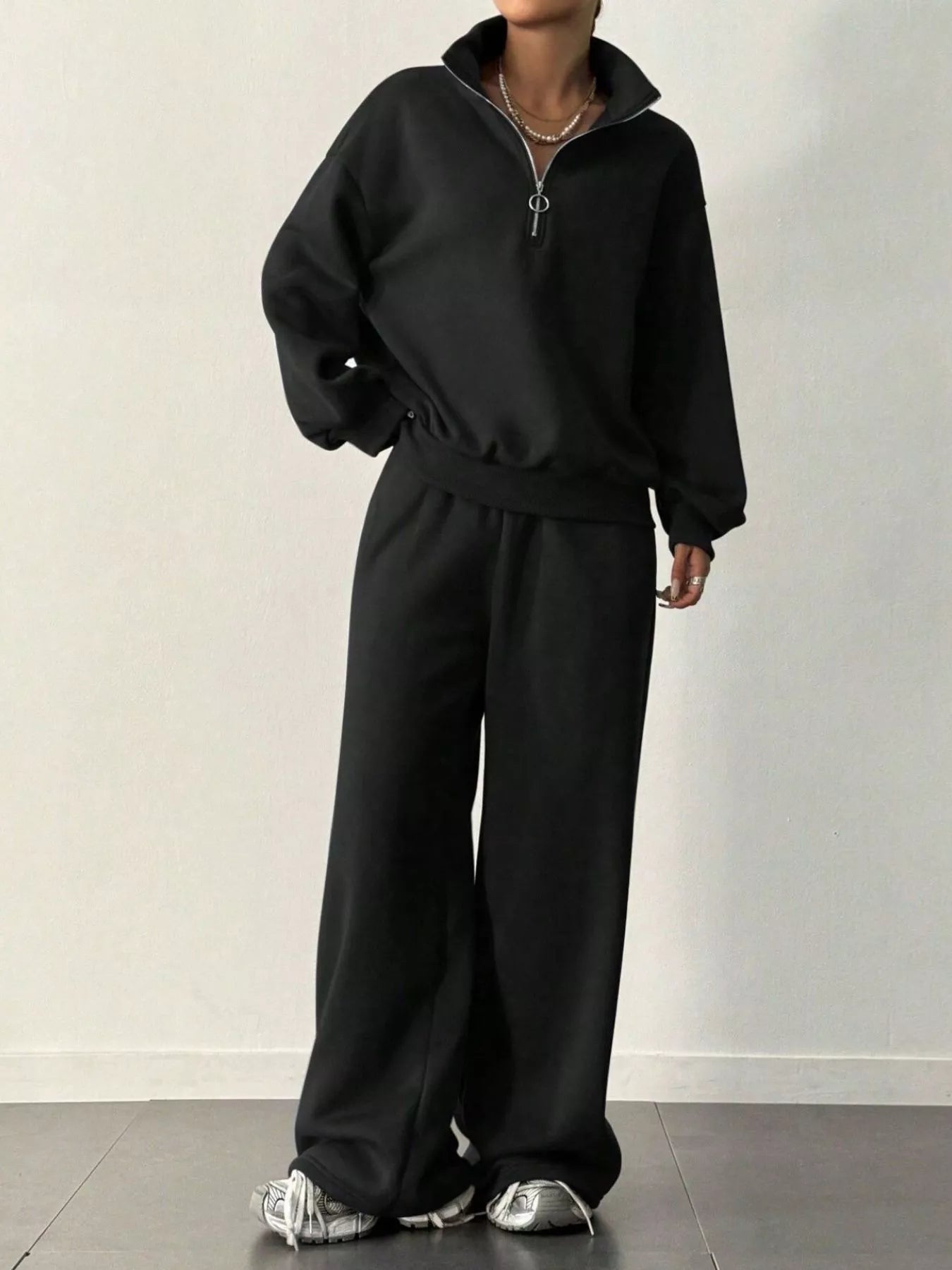Front view of Half-Zip Long Sleeve Sweatshirt and Pants Set in Black showing neckline and sleeve details
