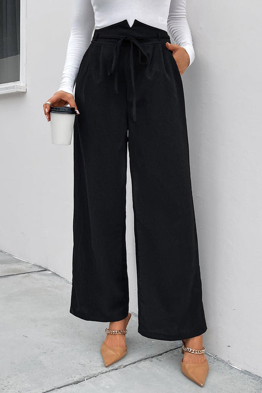 Front view of Perfee High Waist Ruched Tie Front Wide Leg Pants in Black showing neckline and sleeve details