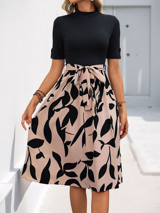Front view of Perfee Tied Printed Mock Neck Short Sleeve Dress in Black showing neckline and sleeve details