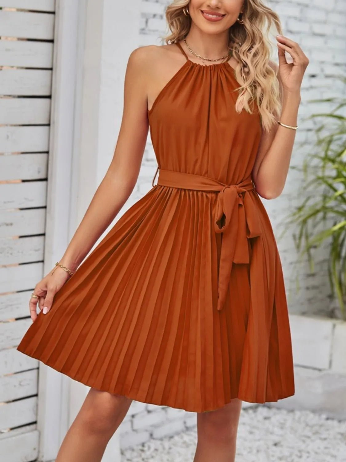 Front view of Pleated Tie Waist Sleeveless Mini Dress in Terracotta showing neckline and sleeve details (95% polyester and)
