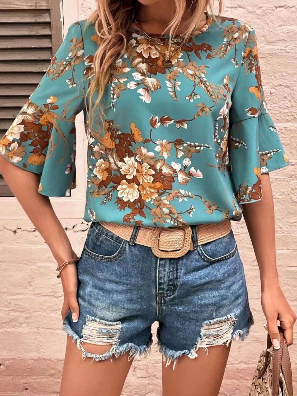Front view of Printed Round Neck Half Sleeve Blouse in Turquoise showing neckline and sleeve details