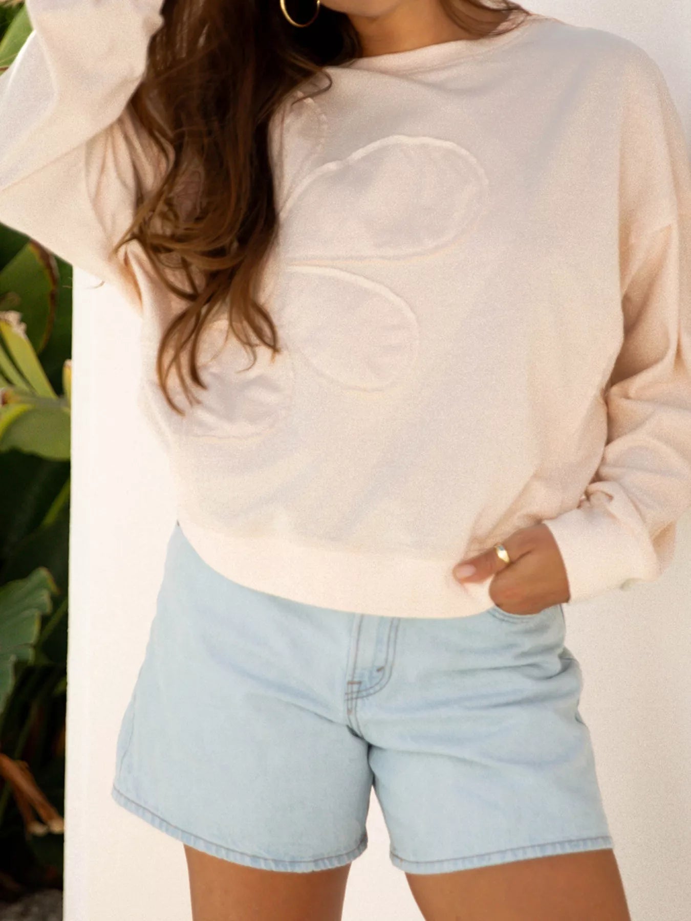 Front view of Raw Edge Flower Patch Drop Shoulder Casual Top in Beige showing neckline and sleeve details