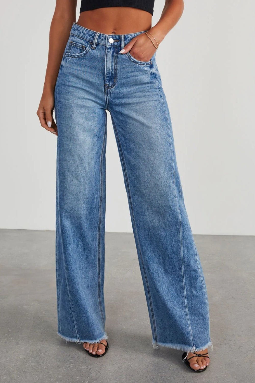 Front view of Raw Hem Wide Leg Jeans with Pockets in Medium showing neckline and sleeve details (100% cotton for durability)