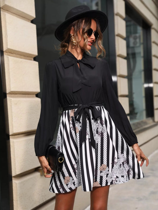 Front view of Striped Tie Front Long Sleeve Mini Dress in Black showing neckline and sleeve details
