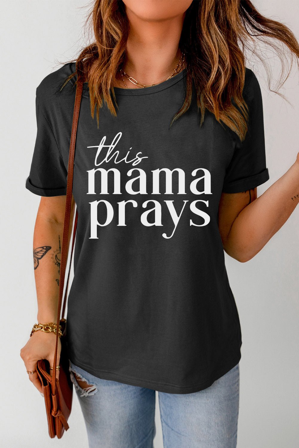 Front view of THIS MAMA PRAYS Graphic Tee in Black showing neckline and sleeve details (95% polyester, 5% spandex for a soft)