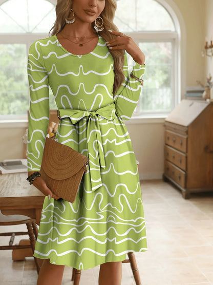 Front view of Wave Print Long Sleeve Tie Waist Dress in Lime showing neckline and sleeve details